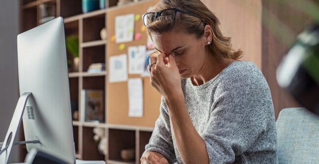 Business woman having headache at office work stress