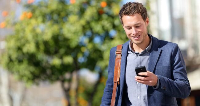 Young urban professional man using smart phone how unplugging can help with stress management