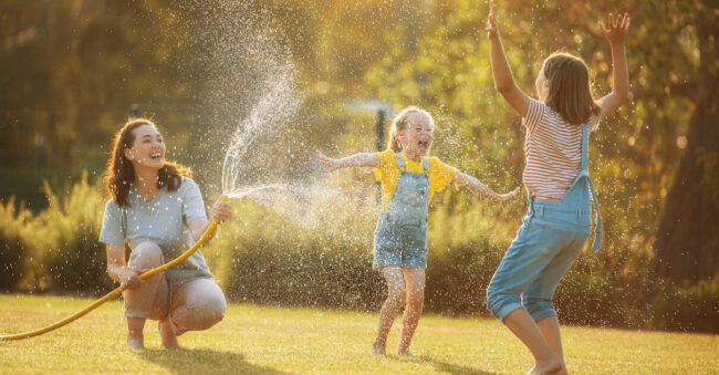 Happy family playing in backyard mindful parenting in the summer